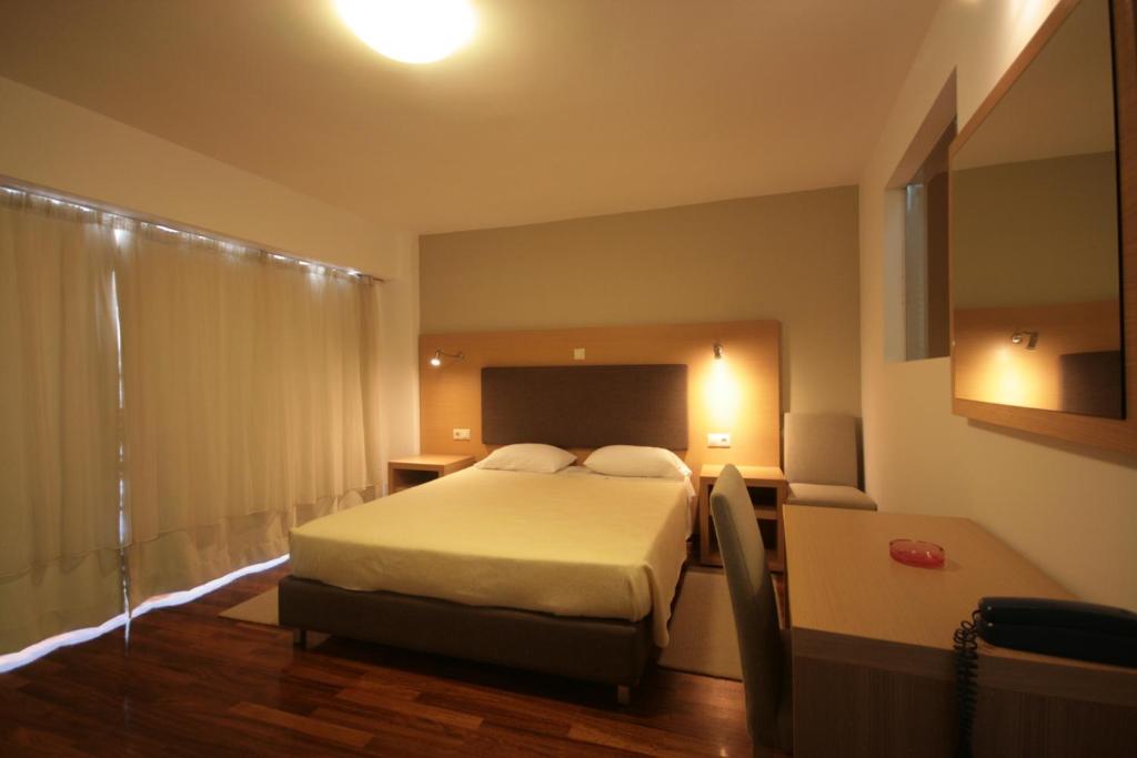 Postel nebo postele na pokoji v ubytování Liberty Hotel