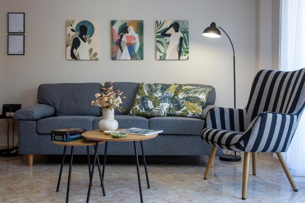 a living room with a couch and a table and chairs at Utopia Inn in Néa Péramos