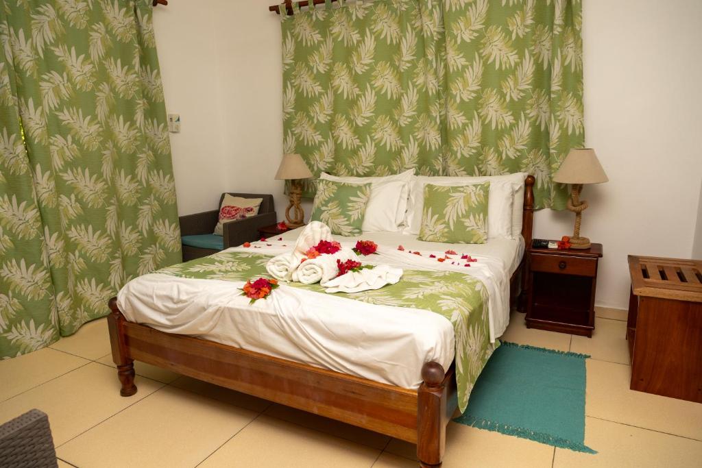 Postel nebo postele na pokoji v ubytování Pension Hibiscus