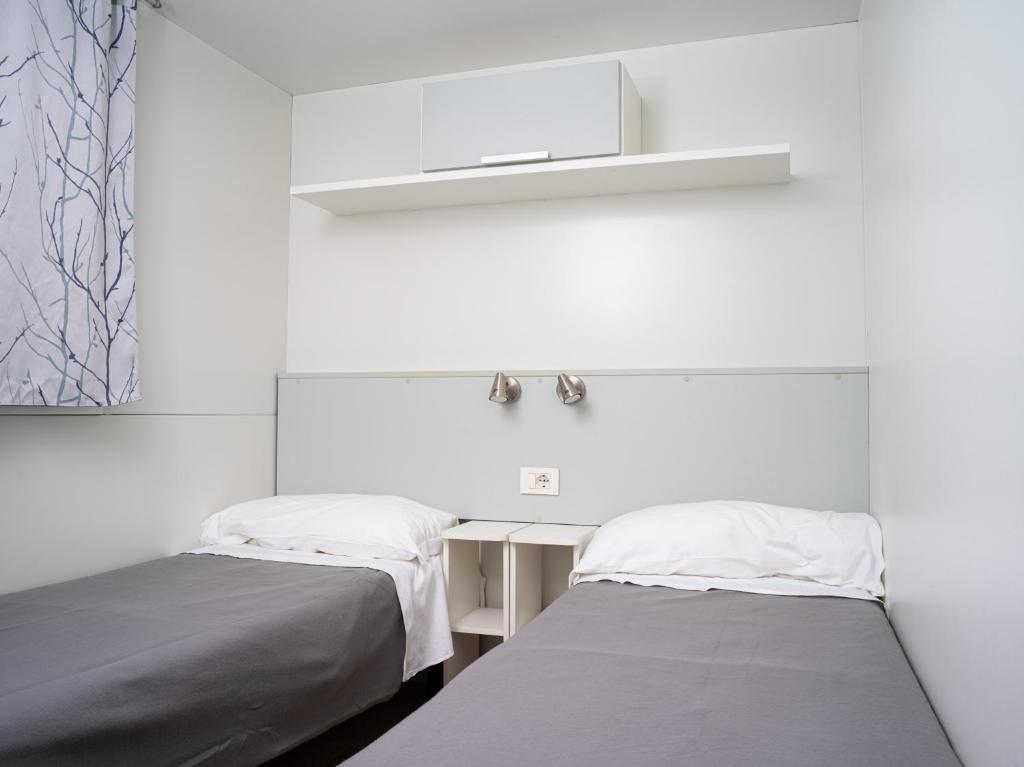 Postel nebo postele na pokoji v ubytování Punta Falconera camping & village