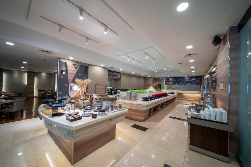 A spacious buffet room with island counters, covered dishes and drink dispensers.