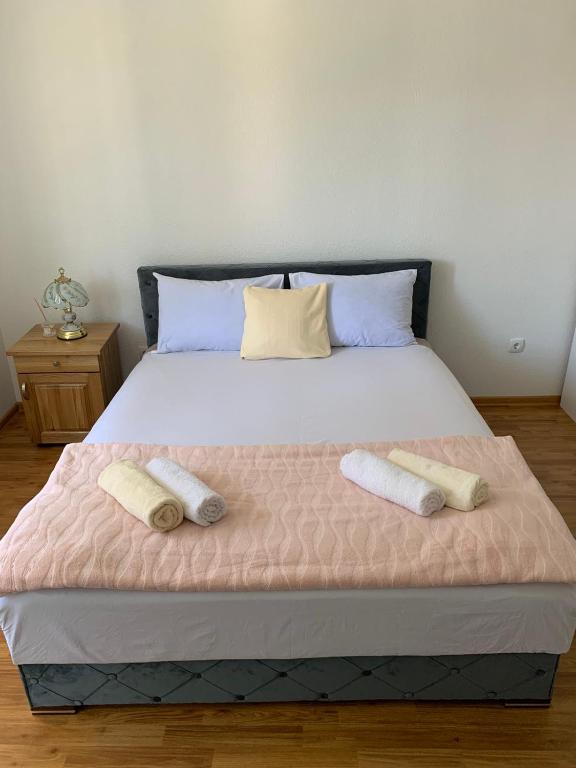 a bedroom with a large bed with two towels on it at Apartman CENTAR 1 in Jajce