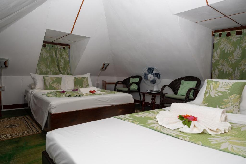 Postel nebo postele na pokoji v ubytování Pension Hibiscus