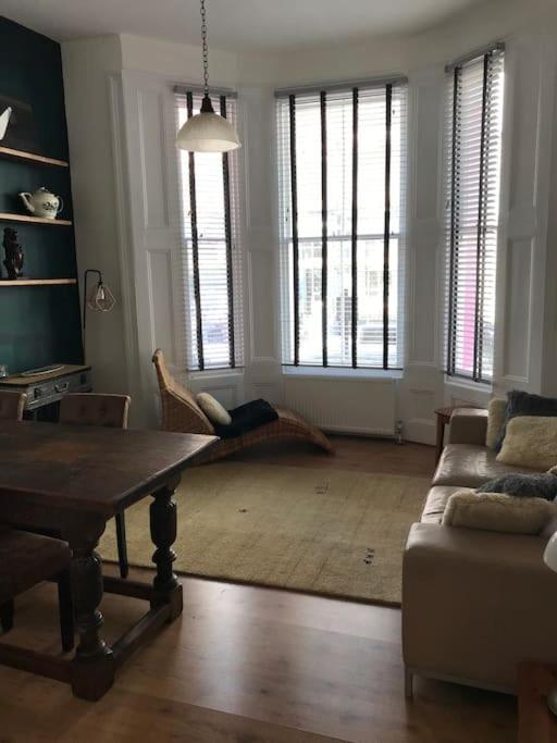 a living room with a table and a couch at Casa Rosa, Notting Hill in London