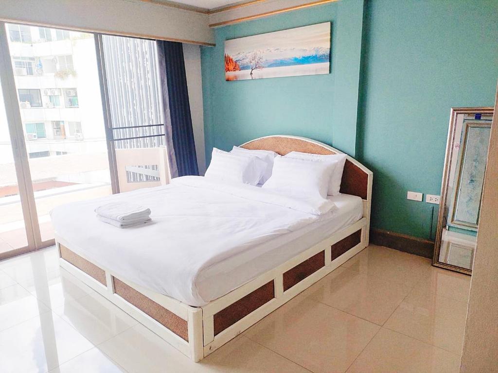 Ένα ή περισσότερα κρεβάτια σε δωμάτιο στο Mitr Inn Nimman 12