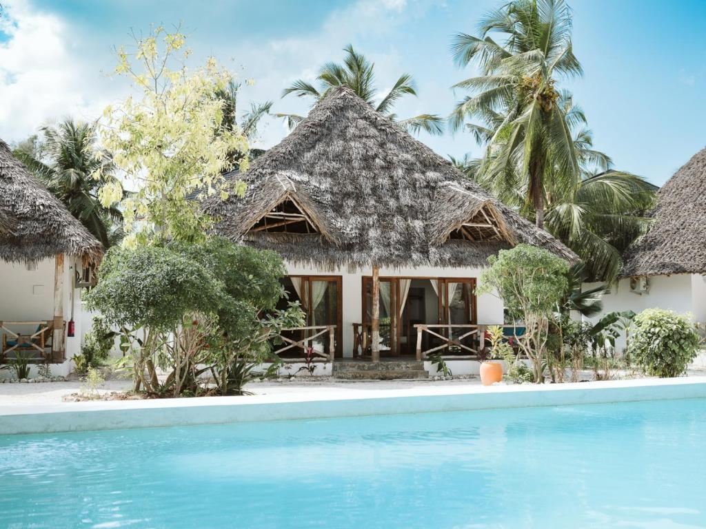 a resort with a swimming pool in front of it at Bahati Sunset Bungalows Michamvi in Michamvi