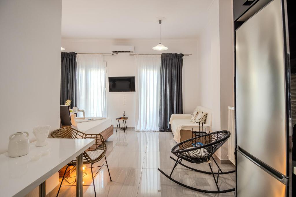 a kitchen and living room with a table and chairs at Pezodromos Apartments in Filiatra