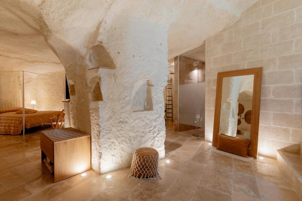 a large living room with a stone wall at Il Belvedere in Matera