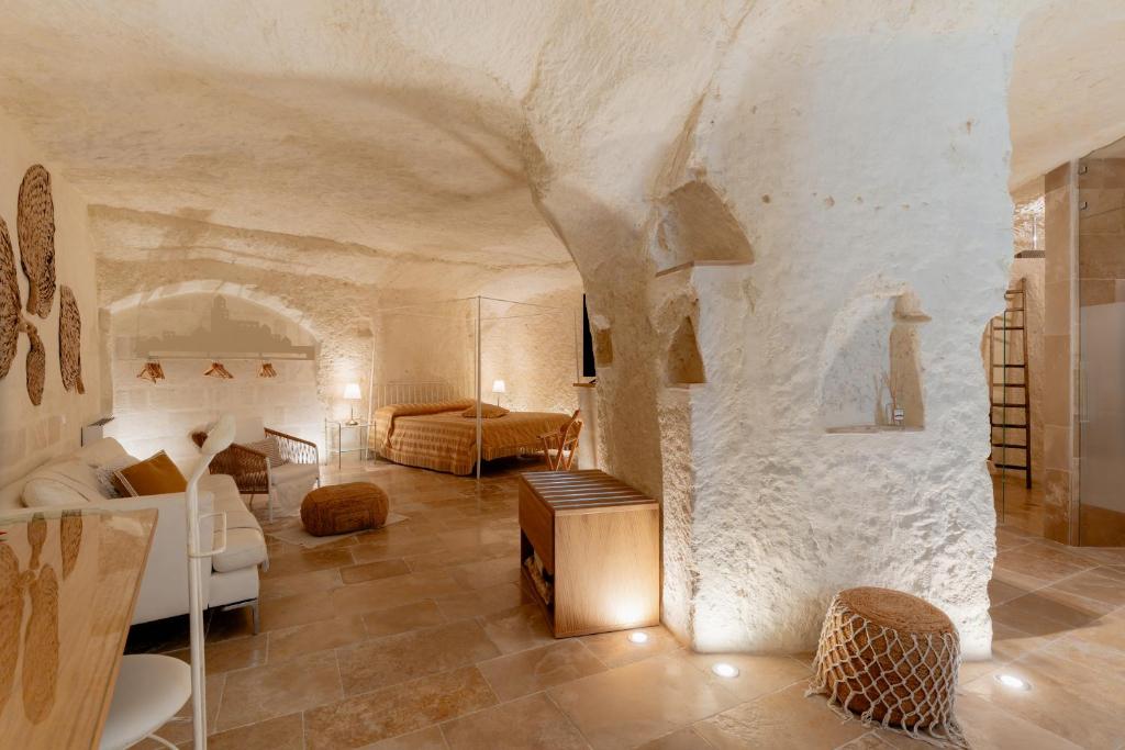 a large living room with a stone wall at Il Belvedere in Matera