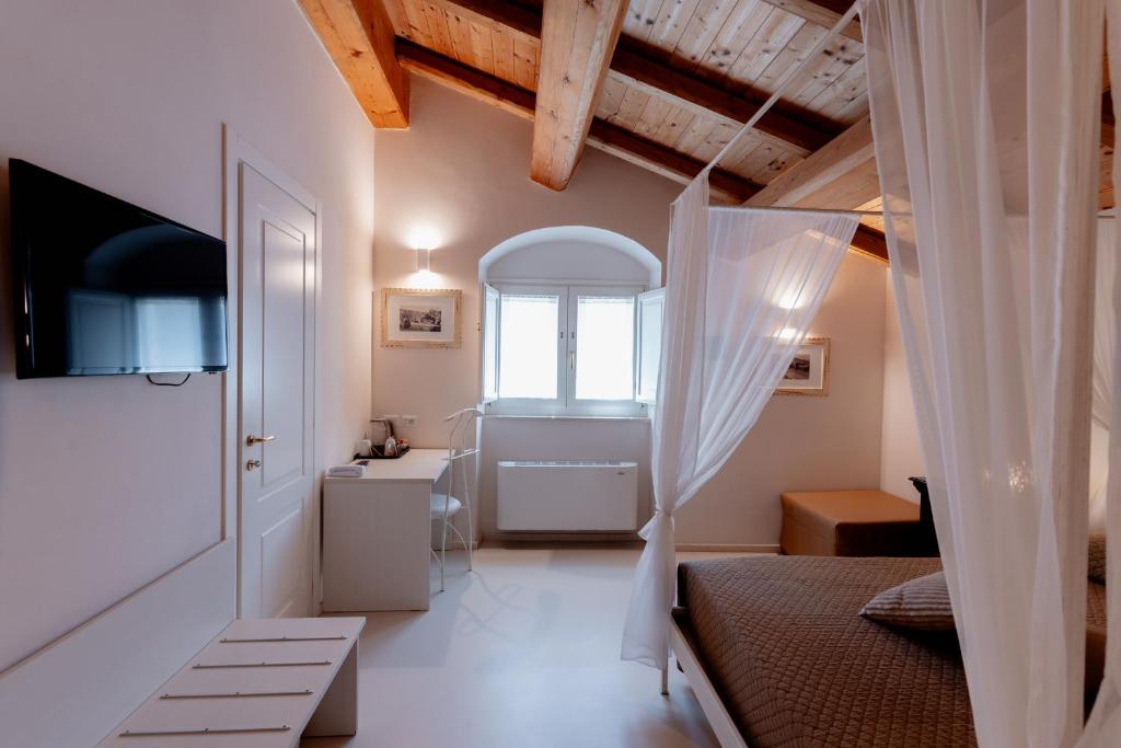 a bedroom with a bed and a sink and a window at Il Belvedere in Matera