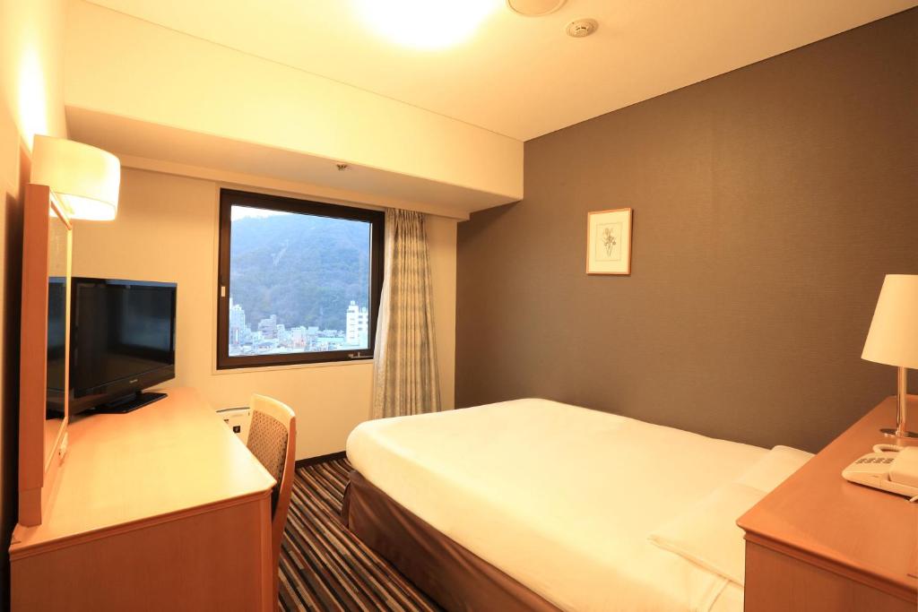 Postel nebo postele na pokoji v ubytování Smile Hotel Tokushima
