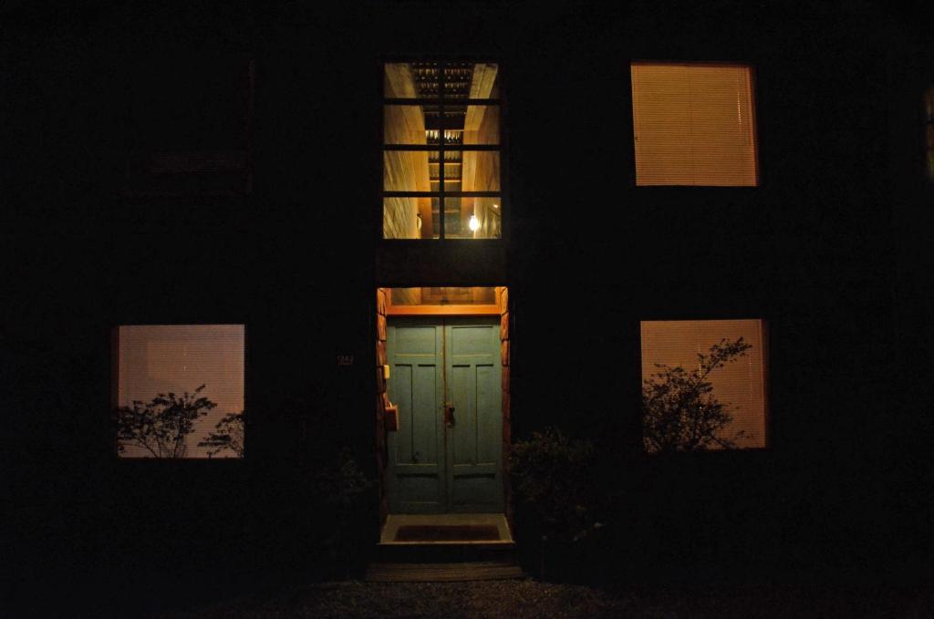 a door in the middle of a building at night at Palafito Azul Apart Hotel in Castro