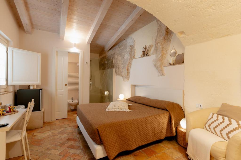 a bedroom with a bed and a couch in a room at Il Belvedere in Matera