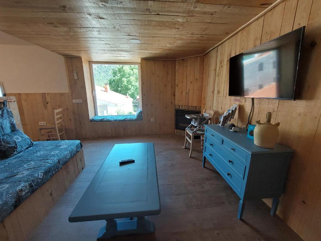 a bedroom with a bed and a tv and a table at Casa Rural La Marquesa - Riópar in Riópar
