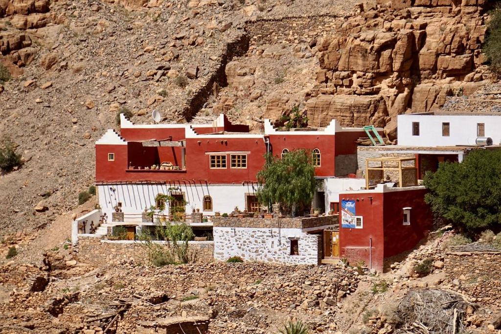 a group of red and white buildings on a mountain at Tigmi Bulbul in Id AÃ¯ssa