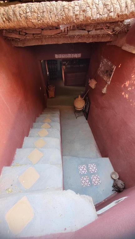 an outside view of a building with a floor and tiles at Tigmi Bulbul in Id AÃ¯ssa