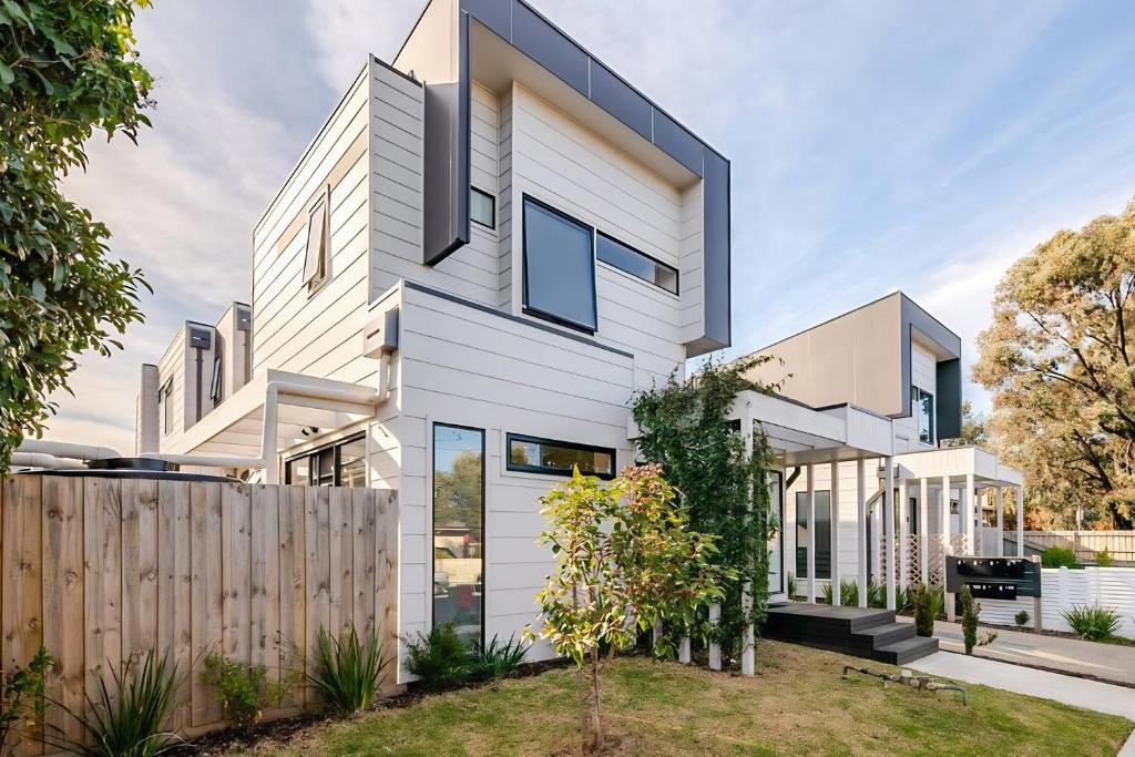 a white house with a fence at Stunning, modern, two-story detached townhouse in Melbourne