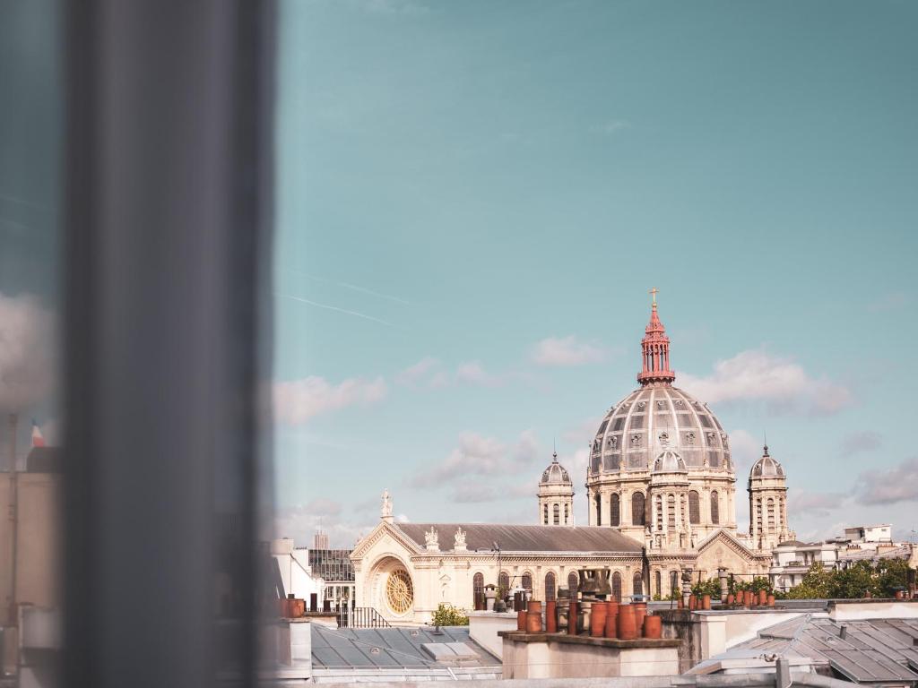a view of a cathedral from a window at Hotel Belleval in Paris
