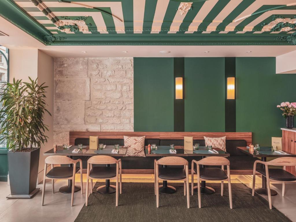 a dining room with a table and chairs at Hotel Belleval in Paris