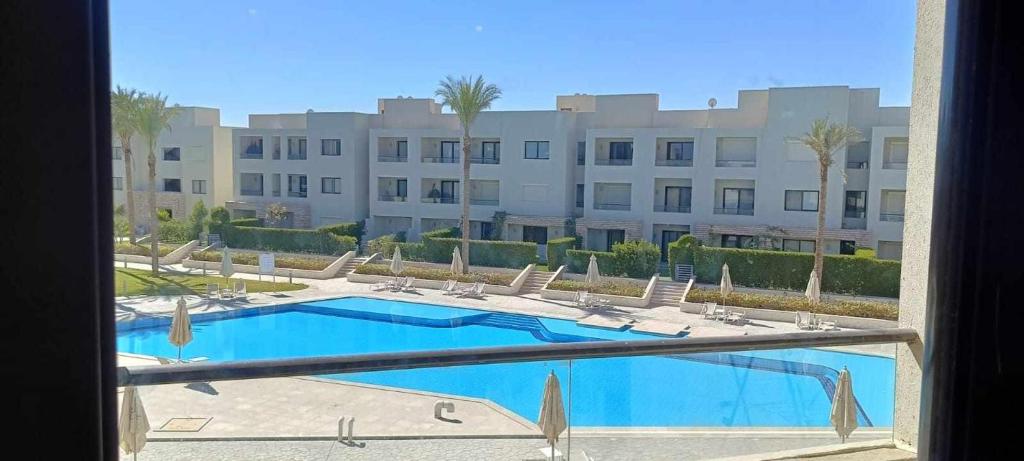 vistas a una piscina con un gran edificio en Sokhna Salty Life Chalet, en Ain Sokhna