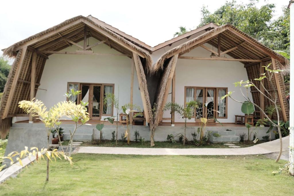 a house with a thatched roof at Alora House Lombok Tete Batu in Tetebatu