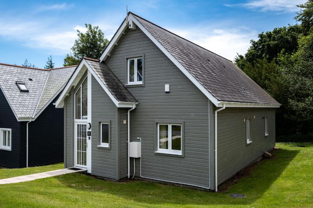 a gray house with a gambrel roof at Trewhiddle Retreat V27 by Together Travel - Luxury 3-Bedroom Villa in St Austell