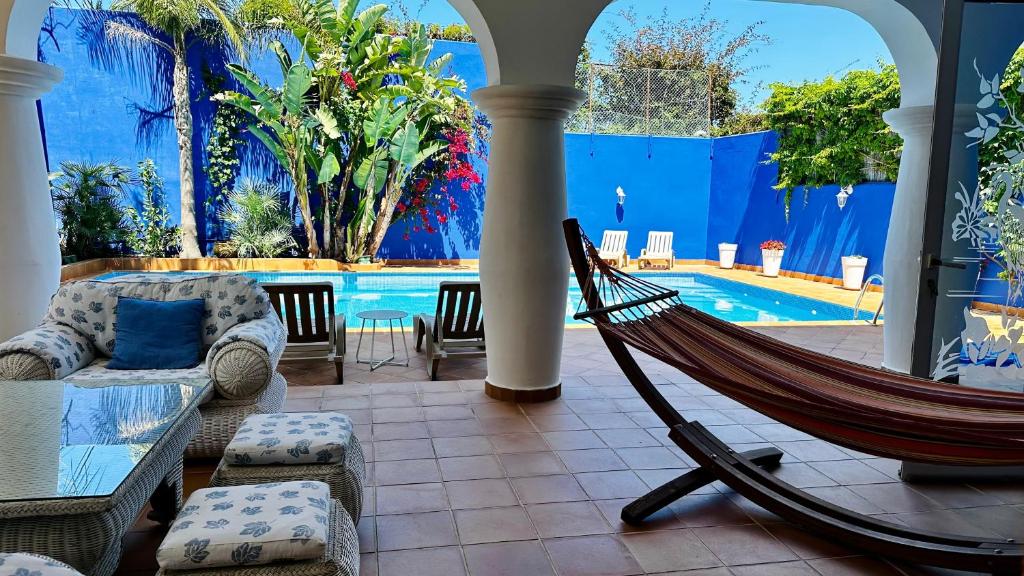 a hammock in a room with a swimming pool at Haddad's for families in Tangier
