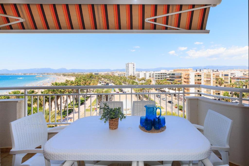 a table on a balcony with a view of the ocean at UHC SANTILLANA FAMILY COMPLEX in Salou
