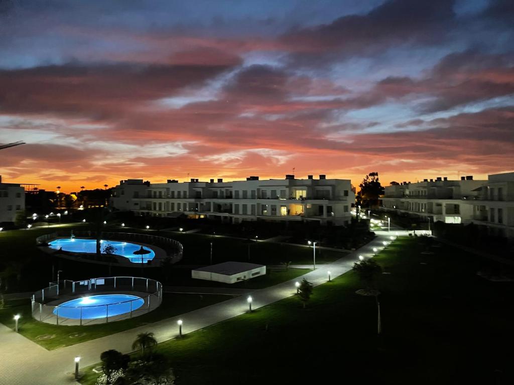 a view of a city at night with street lights at Beach House Costa Ballena in Chipiona