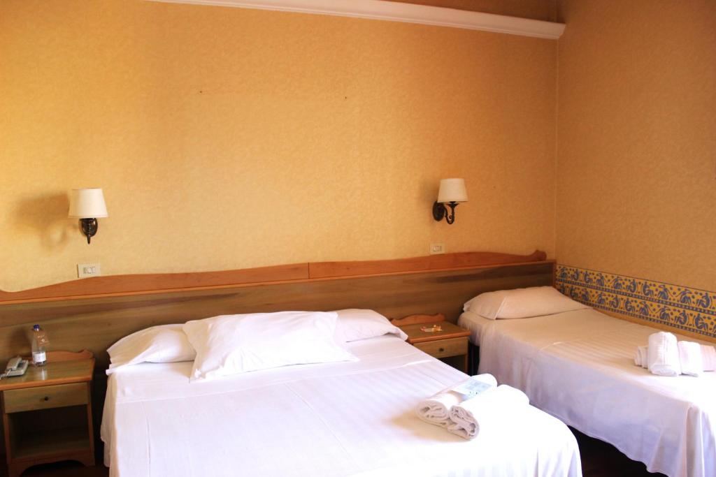 Postel nebo postele na pokoji v ubytování Phi Hotel Ambra