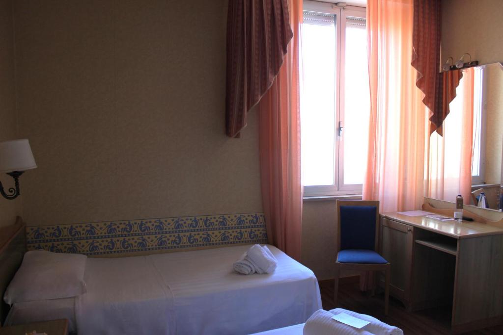Postel nebo postele na pokoji v ubytování Phi Hotel Ambra