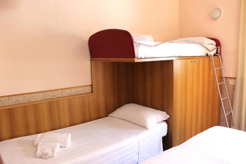 Postel nebo postele na pokoji v ubytování Phi Hotel Ambra