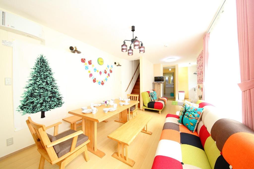 a living room with a christmas tree on the wall at Sun River Annex Inaho - Vacation STAY 95961 in Kita-hamachō