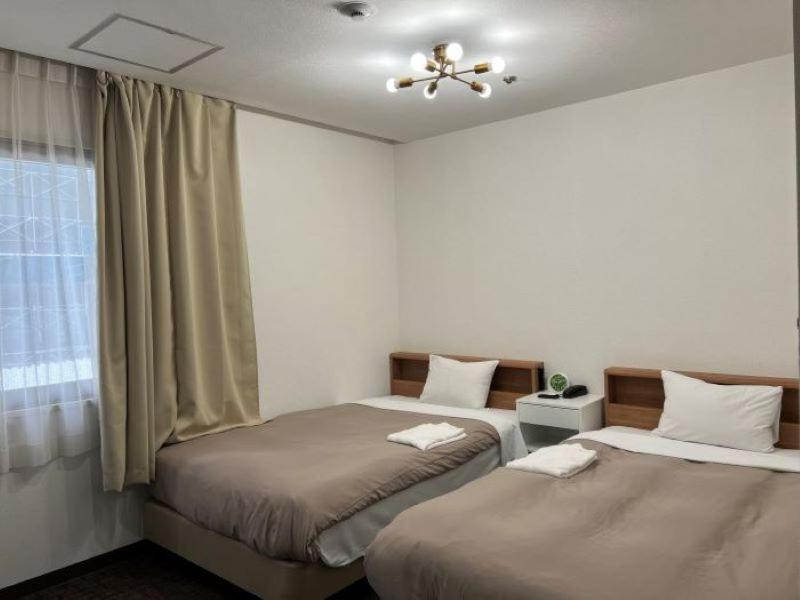 Postel nebo postele na pokoji v ubytování Hotel Royal Oak Gotanda