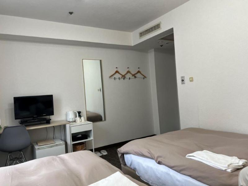 Postel nebo postele na pokoji v ubytování Hotel Royal Oak Gotanda