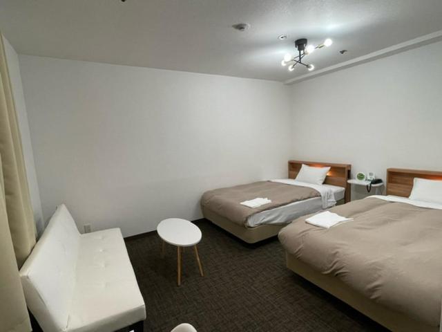Postel nebo postele na pokoji v ubytování Hotel Royal Oak Gotanda