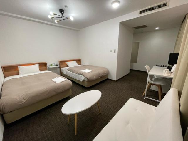 Postel nebo postele na pokoji v ubytování Hotel Royal Oak Gotanda