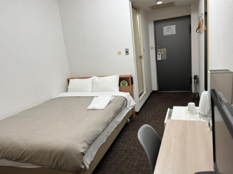 Postel nebo postele na pokoji v ubytování Hotel Royal Oak Gotanda