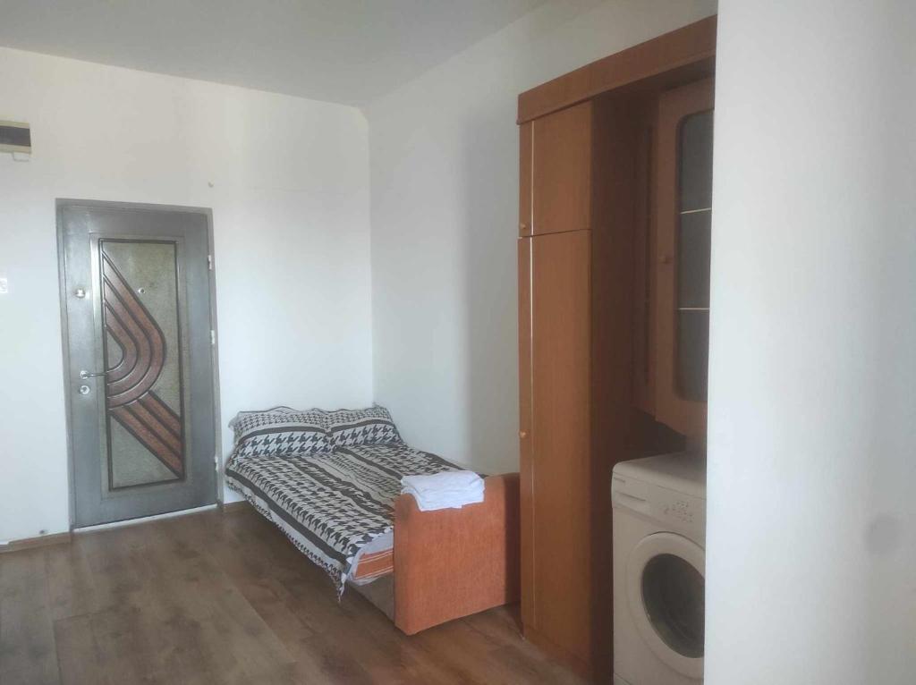 a small room with a washer and dryer next to a door at Navy Sky View - Garsoniera confort I in Tulcea