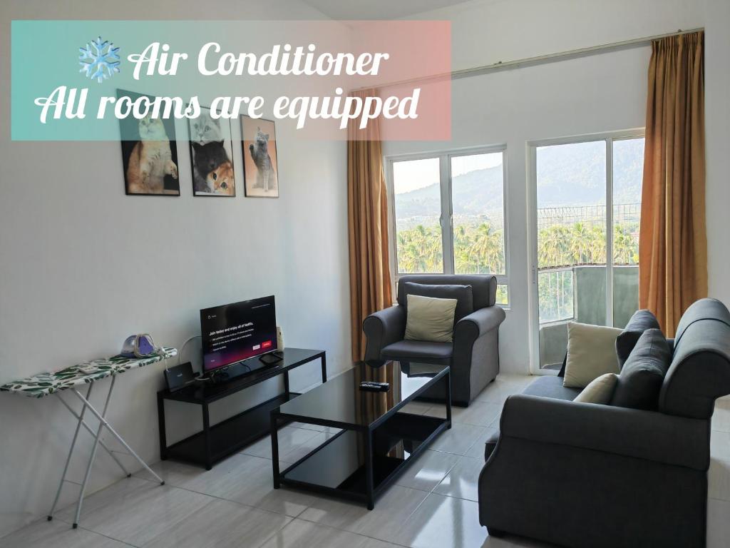a living room with a couch and a chair at Langkawi Homestay Family Suite 3Bed Room in Kuah