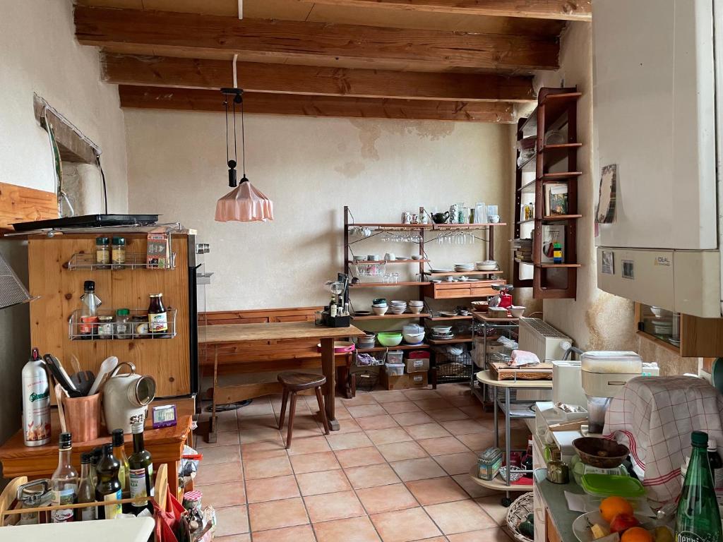 a kitchen with a table and a counter in a room at L'Adventice in Riec-sur-Bélon