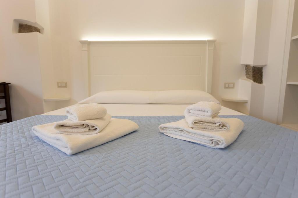 two towels are sitting on top of a bed at San Francesco Tropea Accomodation in Tropea