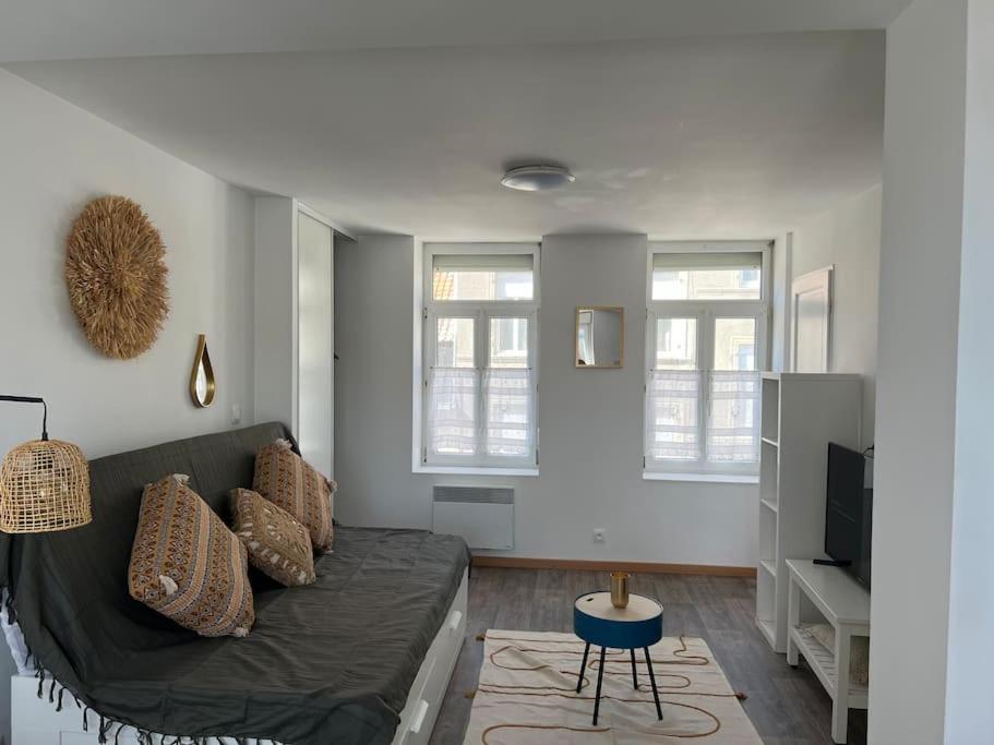 un salon avec un canapé et une télévision dans l'établissement Studio boulonnais, à Boulogne-sur-Mer