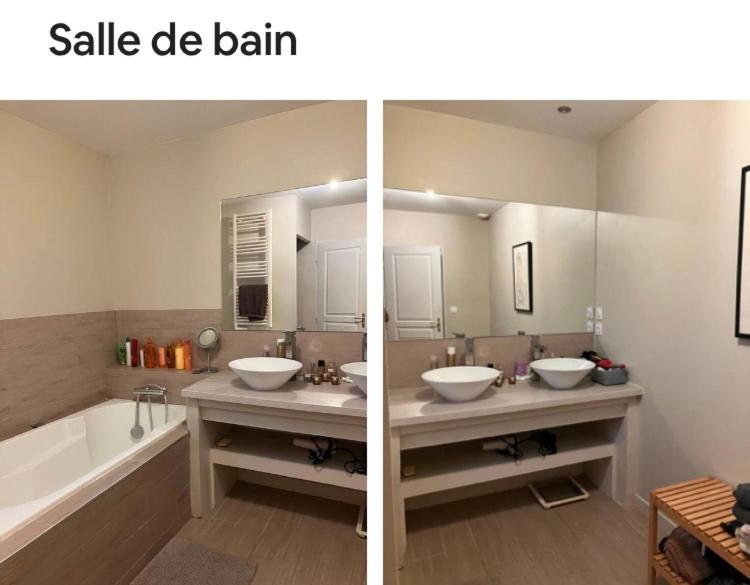 une salle de bain avec deux lavabos, une baignoire et un miroir dans l'établissement Villa 10mn de St Rémy de Pce, à Maillane