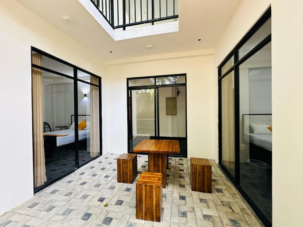 a room with a wooden table and some windows at Large 4 Bedroom Spacious Apartment in Nugegoda, Colombo in Nugegoda