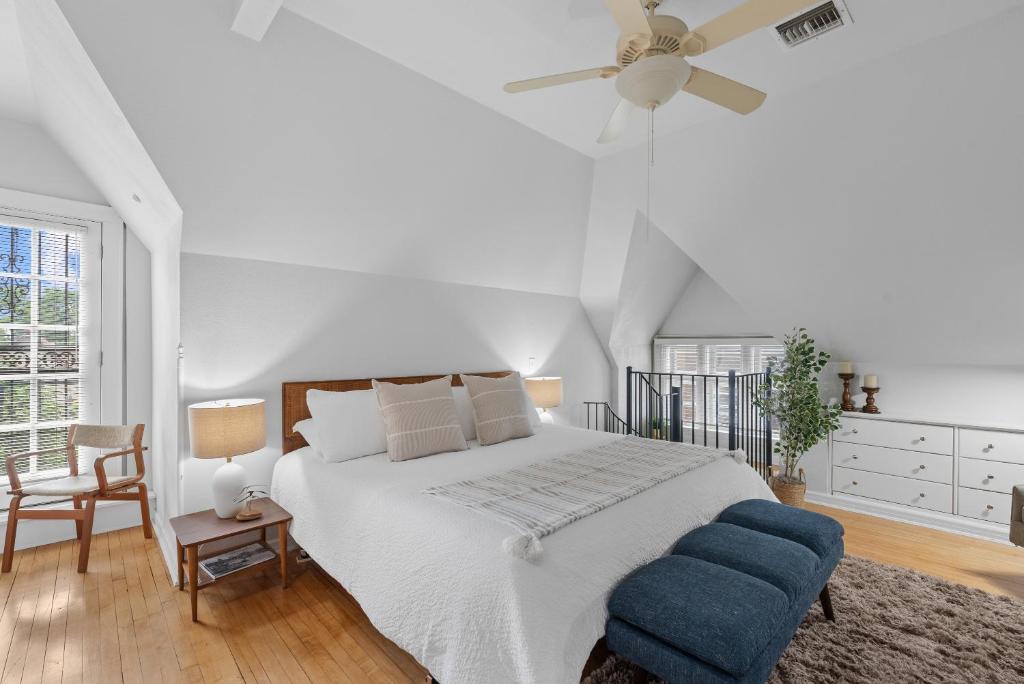 a white bedroom with a bed and a ceiling fan at The Uplifting Mansion in Milwaukee