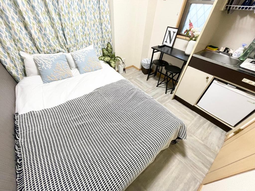 Ένα ή περισσότερα κρεβάτια σε δωμάτιο στο シャンテ高田馬場12