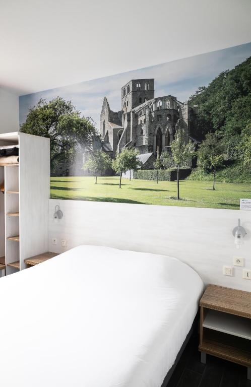 Postel nebo postele na pokoji v ubytování Brit Hotel Confort Saint-Lô
