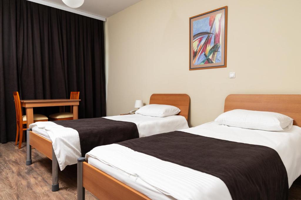 Postel nebo postele na pokoji v ubytování Hotel Luxor