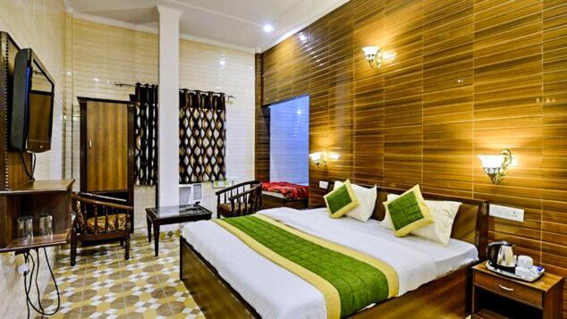a bedroom with a large bed in a room at HOTEL HOLY CITY in Amritsar